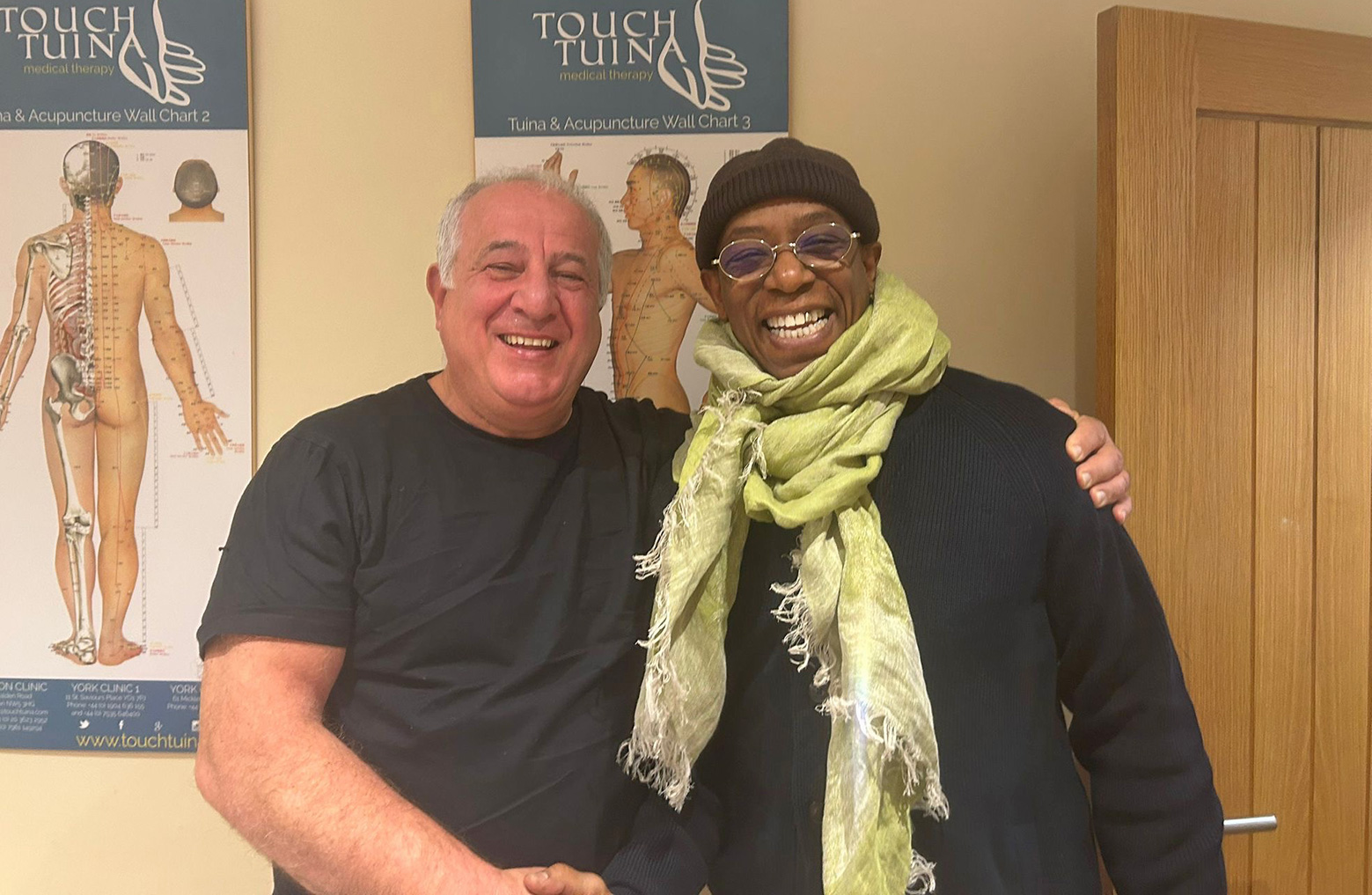 Ian Wright pictured with a Touch Tuina client and lifelong Arsenal supporter