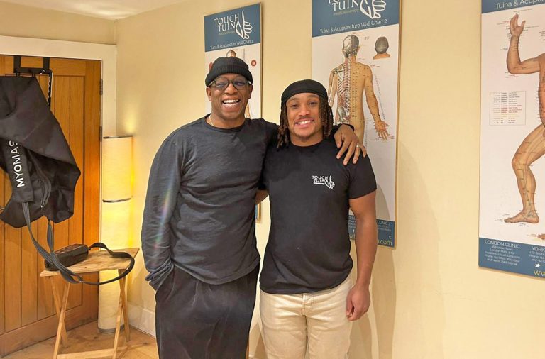 Ian Wright is pictured with Touch Tuina practitioner Tyler