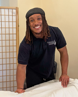 Touch Tuina Practitioner Tyler working at the Kentish Town clinic